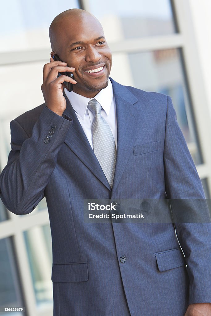 African American Businessman Talking on Cell Phone Successful African American businessman or man talking on his cell phone in a modern city 30-39 Years Stock Photo