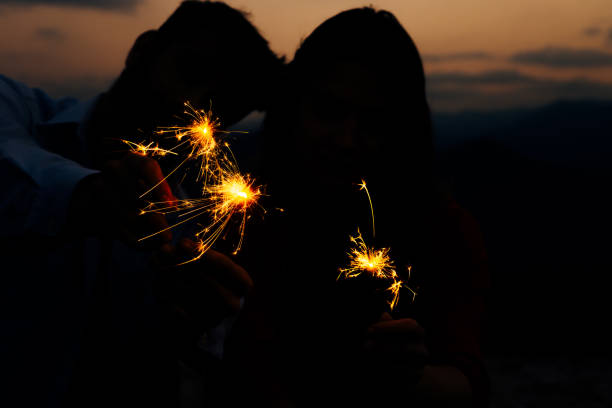 istock Young people in mountain cliff having fun with fires 1366298879