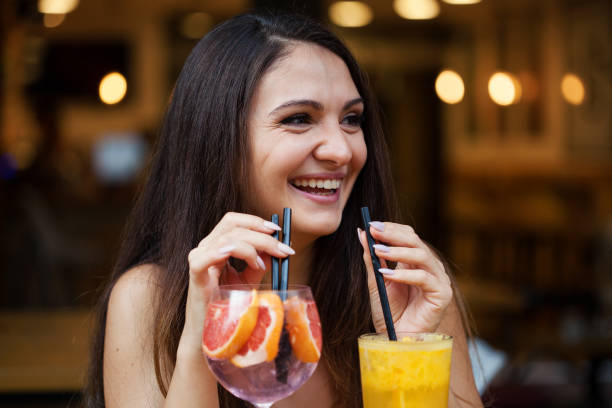 istock Beautiful young woman drinking cold drinks 1366300193