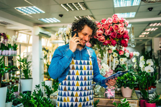 istock Florist man talking to customer on phone 1366302642