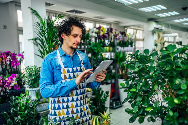 istock Florist using digital tablet in flower shop 1366304871