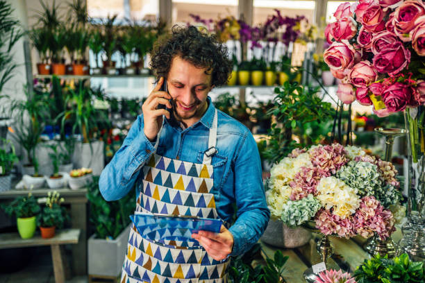 istock Florist man talking to customer on phone 1366305526