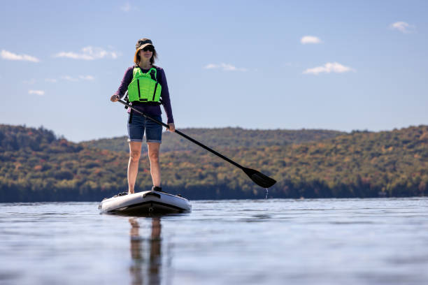 istock Woman Paddleboarding on the Lake in Autumn, Quebec, Canada 1366310064