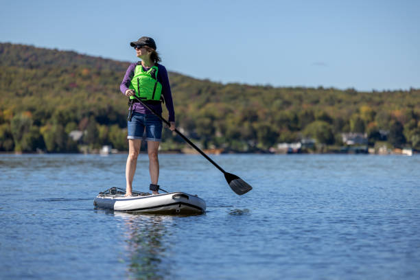 istock Woman Paddleboarding on the Lake in Autumn, Quebec, Canada 1366310071
