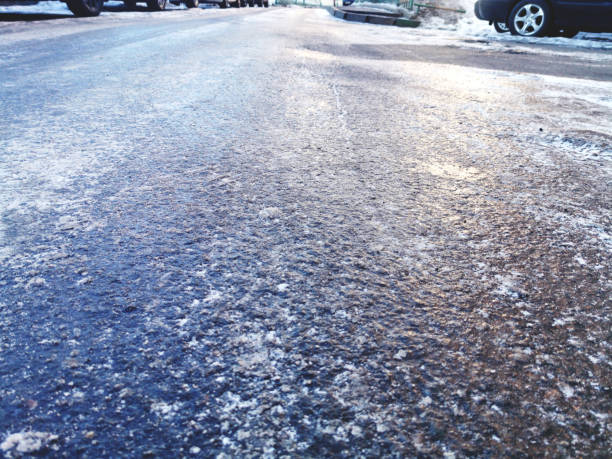texture of asphalt road covered with ice, slippery road winter