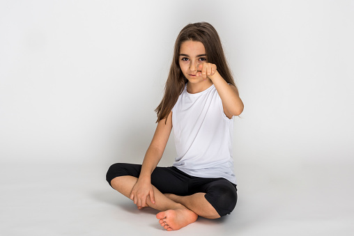 Close up of frustrated teenager girl in stress with furious face. Looking mad and disappointed making angry gestures. In neutral background. In human facial expressions and emotions.