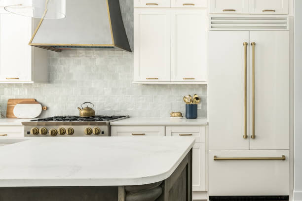 contemporary white kitchen with white matte appliances and gold fixtures - matte imagens e fotografias de stock