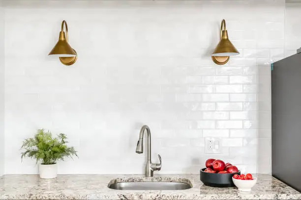 Photo of Bright White Kitchen with Subway Tile and Gold Fixtures