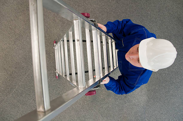 worker enters the ladder stock photo