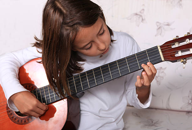 istock Young girl play classical guitar 136631779