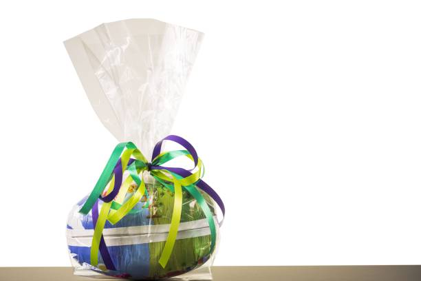 A table with gifts and birthday presents behind a windowpane wirh refelctions  in the glass