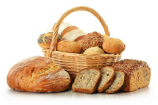 istock Loafs of bread and rolls in basket isolated on white 136632022