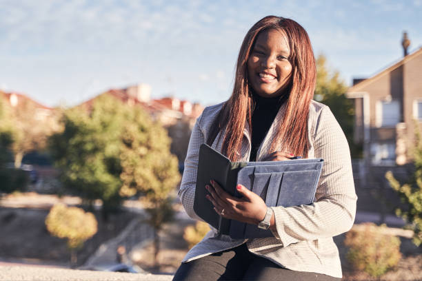 african-american law student on the university campus. woman in suit with folder in hand looking at camera. - law student imagens e fotografias de stock