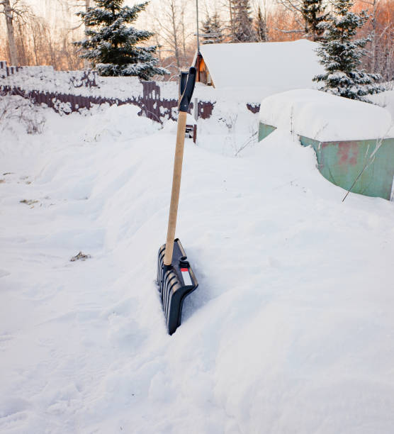 istock a black plastic shovel with a wooden handle stuck in fluffy white snow 1366324208