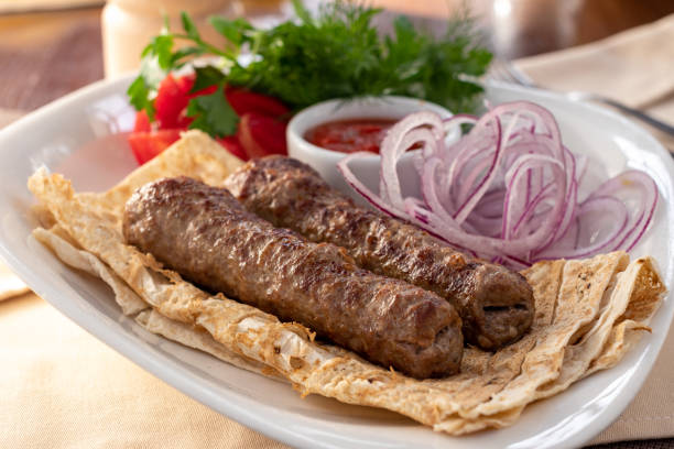 istock Lamb Lula kebab with red onion and sauce on white plate 1366325511