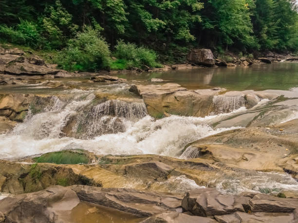 istock Beautiful Wild river running through the forest stock photo 1366328036