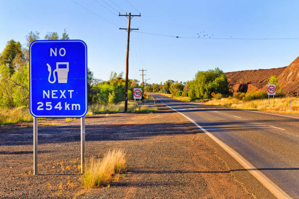 Mirage over straight endless road in Australia merging asphalt and sky
