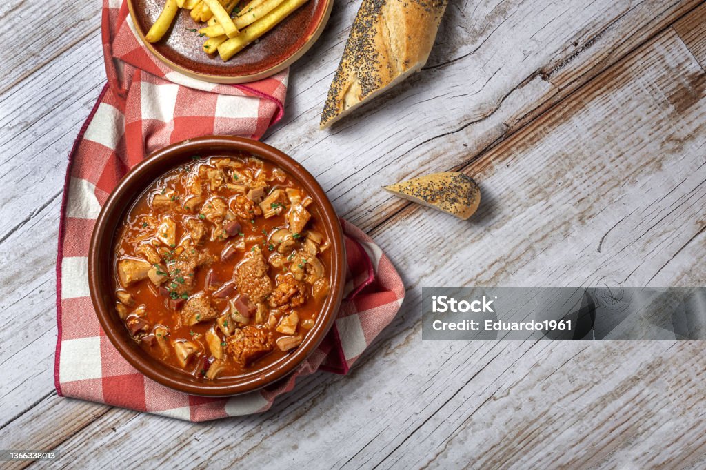 Traditional homemade and typical tripe recipe Madrid style with bread and French fries Traditional homemade and typical recipe callos a la madrileÃ±a with bread and french fries. Spanish food concept Tripe Stock Photo