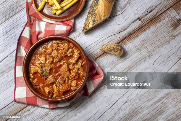 Traditional Homemade And Typical Tripe Recipe Madrid Style With Bread And French Fries Stock Photo - Download Image Now