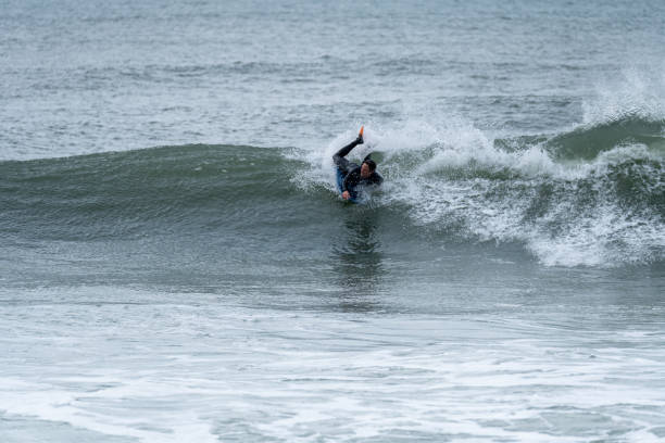 istock Bodyboarder surfing ocean wave 1366340235