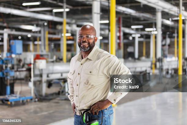Africanamerican Man Working In Plastics Factory Stock Photo - Download Image Now - Blue-collar Worker, Manufacturing, Small Business