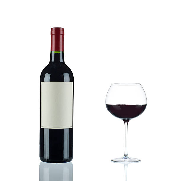 Red Wine in a Bordeux Bottle and Glass stock photo