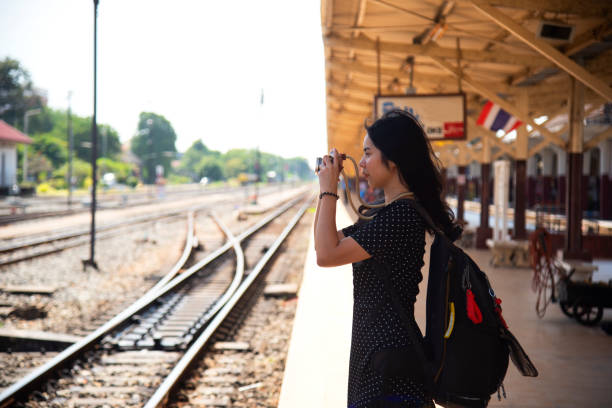 young asian woman smilingTraveler girl walking and waits train on railway platform young asian woman smilingTraveler girl walking and waits train on railway platform irish travellers photos stock pictures, royalty-free photos & images