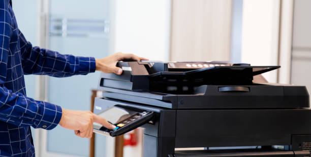 istock Businessmen press button on the panel for using photocopier or printer for printout and scanning document paper at office. 1366350184