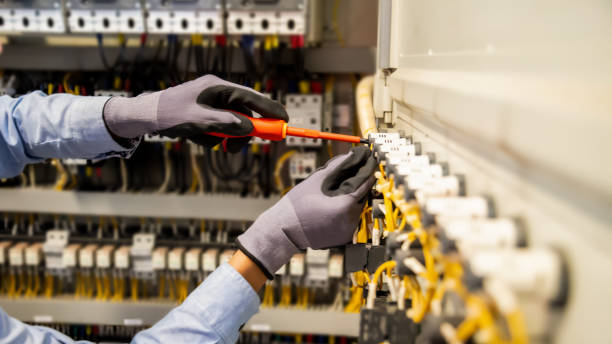 istock Electricians work to connect electric wires in the system, switchboard, electrical system in Control cabinet. 1366350235