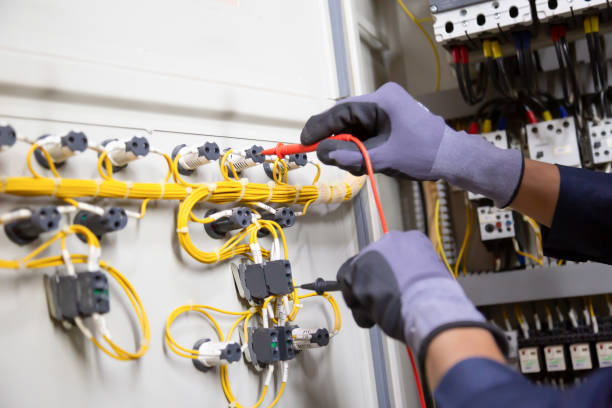 istock Electrician engineer tests electrical installations and wires on relay protection system. Adjustment of scheme of automation and control of electrical equipment. 1366350295