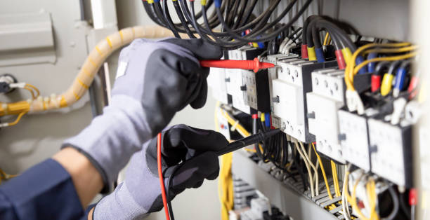 istock Electrician engineer tests electrical installations and wires on relay protection system. Adjustment of scheme of automation and control of electrical equipment. 1366350300