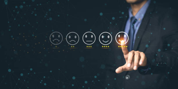istock Customer Service and Satisfaction Concept Businessmen touch the virtual screen on happy smiley icons to achieve service satisfaction and feedback with excellent rated reviews. 1366350344