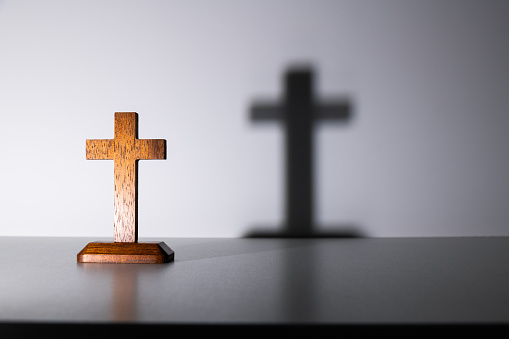 Wooden cross on the table.