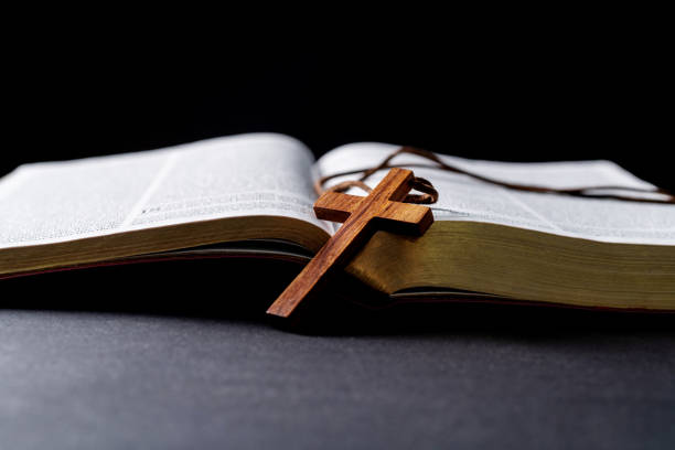istock Wooden cross and bible on the table 1366351889