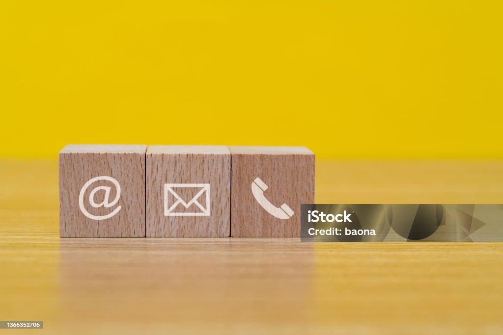 Contact us icons on wooden block shapes Contact us icons on wooden block shapes. Contact Us Stock Photo
