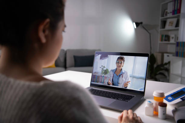 istock Asian female patient talk consult with physician online on webcam conference on computer. 1366353481