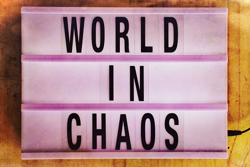 The Words 'World In Chaos' in a Lightbox for a Concept in Lessons in Togetherness. This is part of my Signs of the Times Collection for 2021, Documenting the Rise in Polarisation of Society.