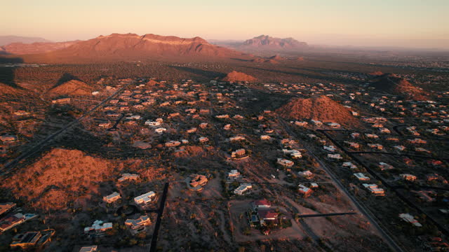 Arizona Sunset Aerial of Rural Residential Homes with Mountains in Background