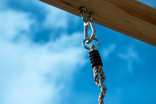 Eye-loop screw mount on bottom of wooden beam.
