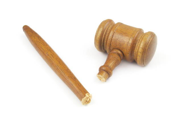 Broken wooden judge gavel isolated on white background. Concept of iniquity, injustice and lawlessness.
