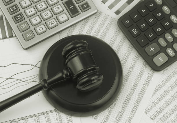 istock Arbitration concept, wooden judge gavel and calculators on financial documents. 1366360296