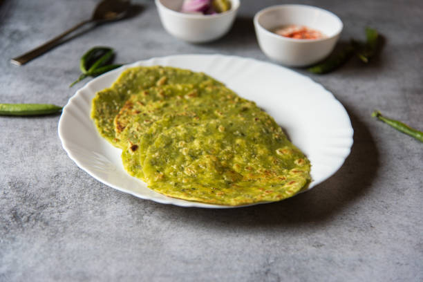 istock Green peas stuffed Indian flat bread or matar ka paratha served in a white plate. 1366360371