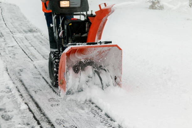 istock A man works with a snow blower to remove freshly fallen snow from a high voltage transformer driveway. 1366361218