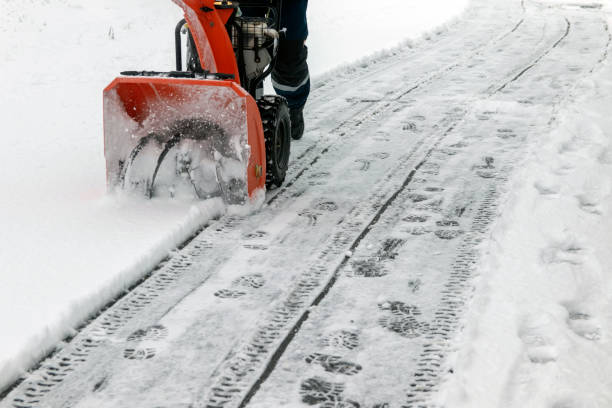 istock A man removes snow from sidewalks with a snow blower in winter at an electrical substation 1366362787