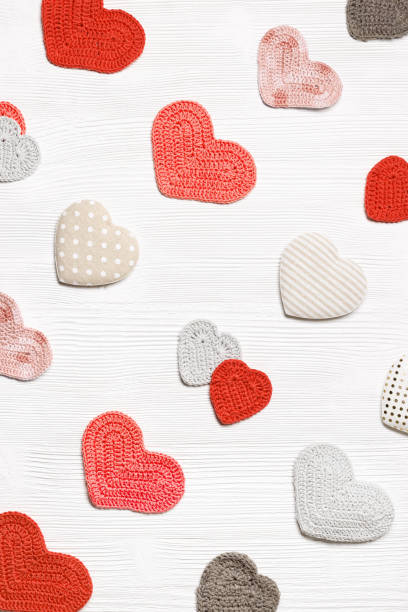 istock Valentines day concept, knit hearts valentine as creative pattern, handmade colored crochet heart on white wooden table, diy gift for romance holiday, symbol of love. Festive background 1366367004