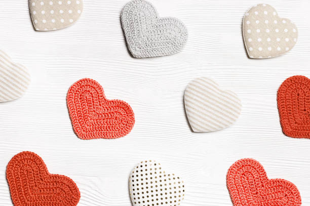istock Valentines day concept, knit hearts valentine as creative pattern, handmade colored crochet heart on white wooden table, diy gift for romance holiday, symbol of love. Festive background 1366367008
