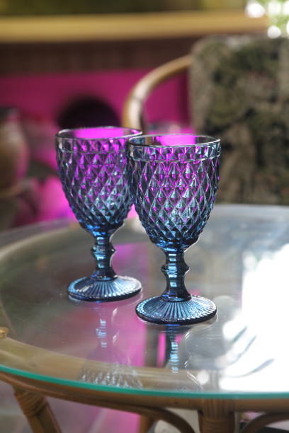 istock Two blue glasses on a glass table 1366372067