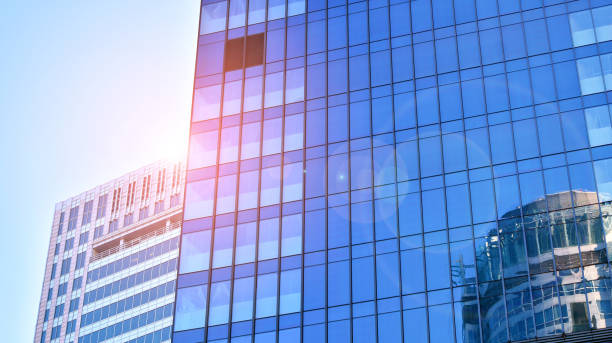 istock Commercial building close up in blue tone. Gigantic skyscraper from below. 1366377085