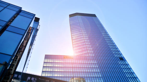 istock Commercial building close up in blue tone. Gigantic skyscraper from below. 1366377145