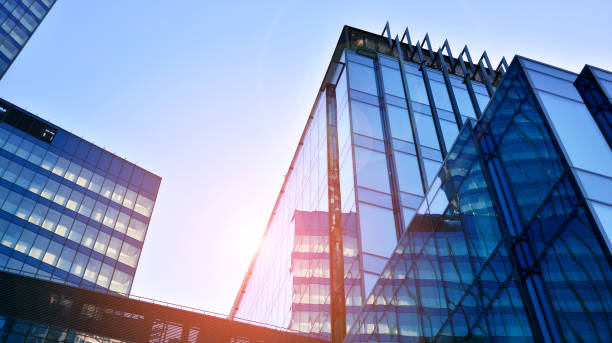 istock Commercial building close up in blue tone. Gigantic skyscraper from below. 1366377829